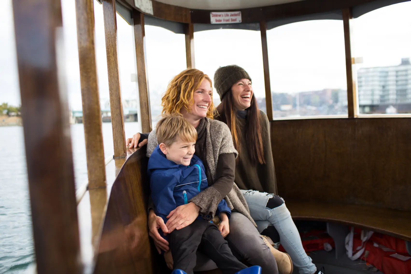 A family on a harbour ferry ride around inner harbour Victoria, BC