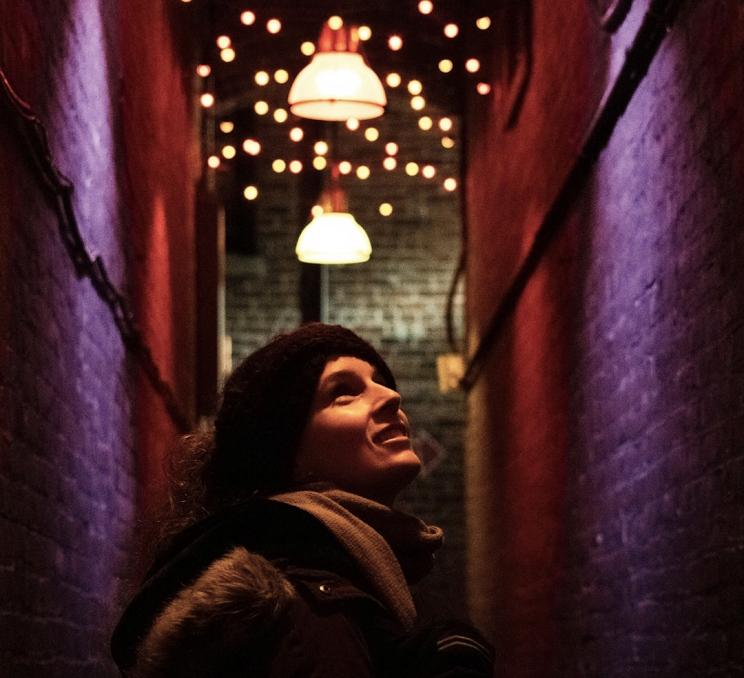 A woman looking at the lights in Fan Tan Alley in Victoria, BC