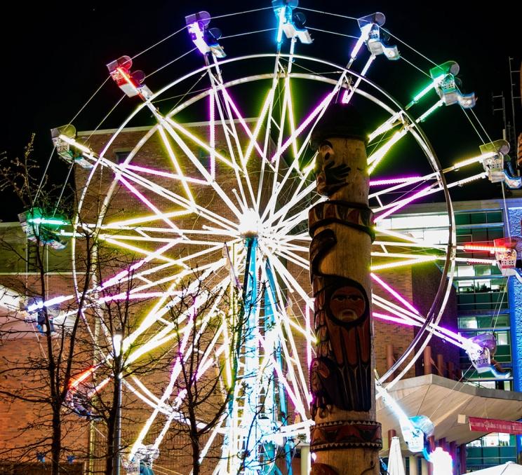 A ferris wheel illuminated at Lights of Wonder in Centennial Square in downtown Victoria, BC