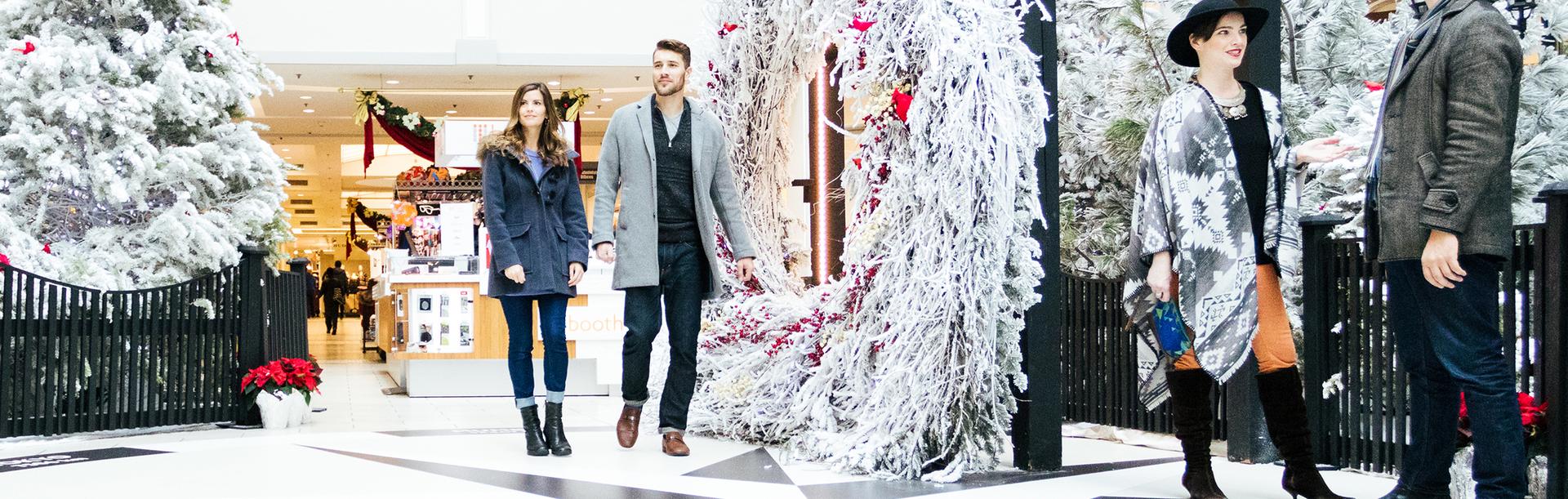A couple walks through a Christmas display at the Bay Centre Shopping Centre in downtown Victoria, BC