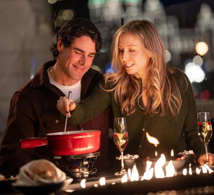 A couple enjoys a fondue while on the Veranda at the Fairmont Empress during wintertime in Victoria, BC