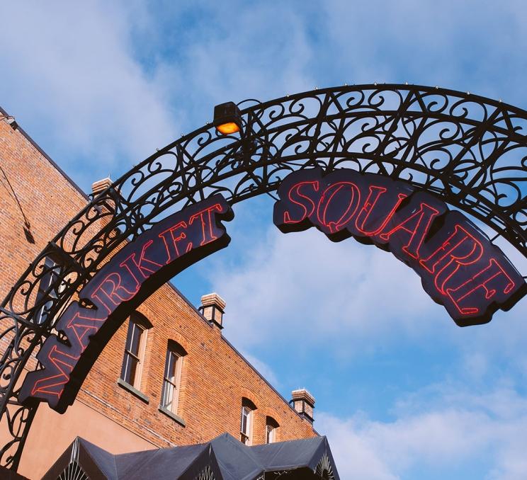 The sign for Market Square hangs above the Johnson Street entrance way in Victoria, BC