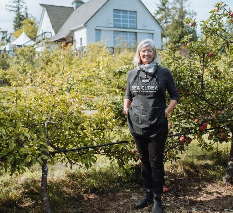 Sea Cider Farm & Ciderhouse Founder Kristen Needham stands in an orchard in Victoria, BC