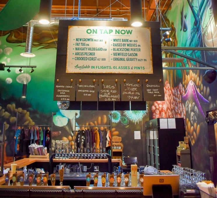 A sign displays beers that are on tap now at Driftwood Brewery in Victoria, BC