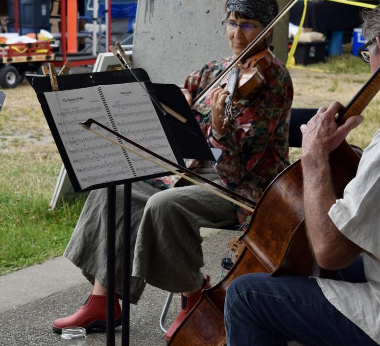Musical performers on stage at Moss Street Market in Victoria, BC