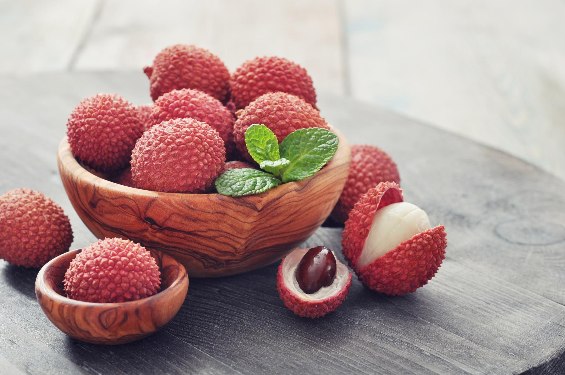 A basket of lychees - a few are peeled to reveal the sweet, white flesh of the fruit