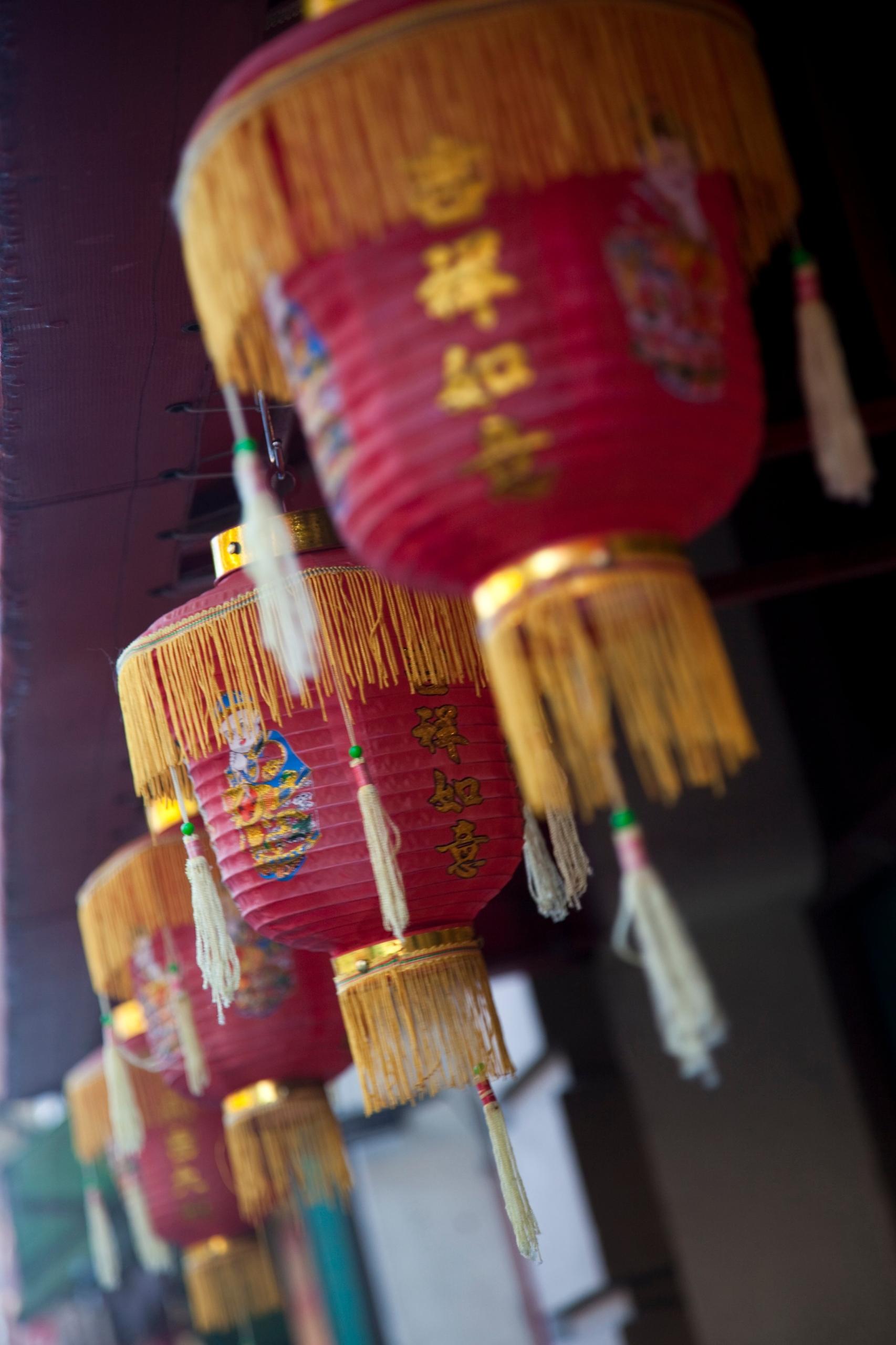 Chinese Lantern ornately decorated in delicate red paper and golden accents