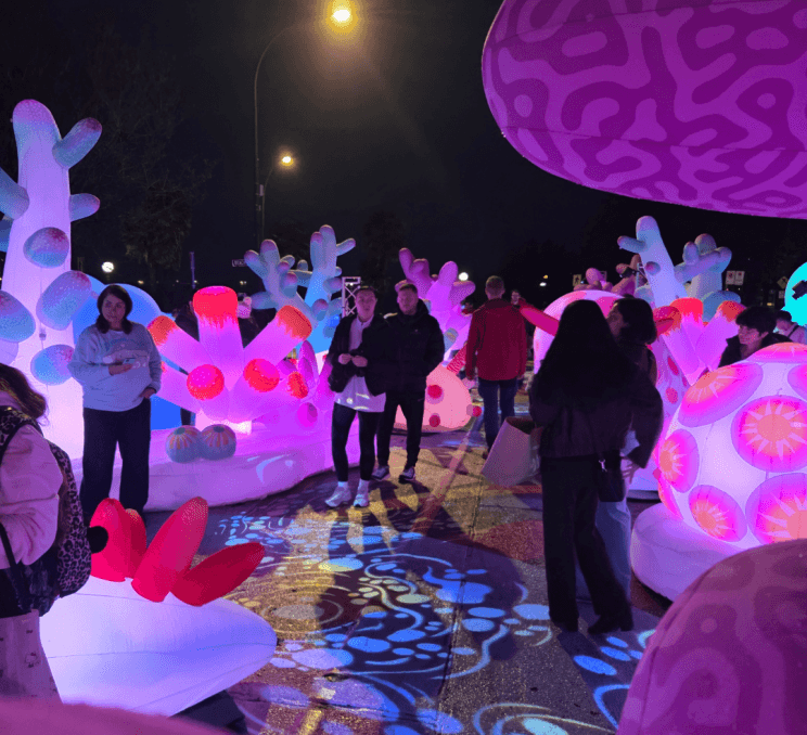 A couple walks through Victoria at Dusk public art displays in Victroia, BC.