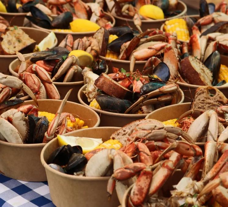 Buckets filled with steamed crab, mussels, and corn at BC Crab Fest in Victoria, BC