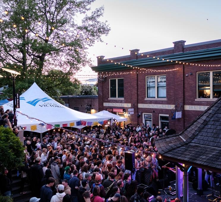 A crowd gathered during a performance at Fern Fest in the Fernwood neighbourhood of Victoria, BC