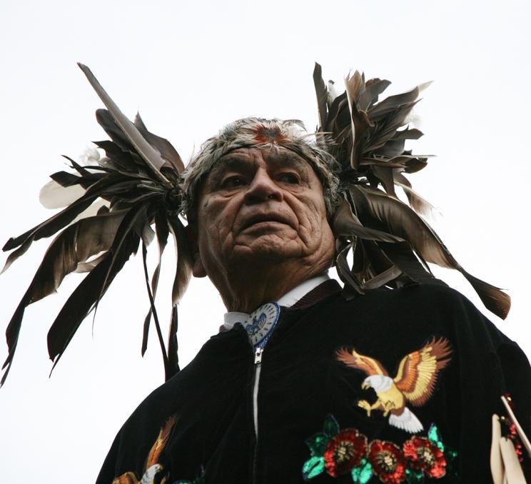 An Indigenous Person in full regalia and headdress at an Indigenous Ceremony in Victoria, BC
