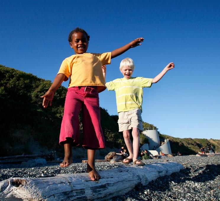 Two children playing on the beach in Oak Bay in Victoria, BC