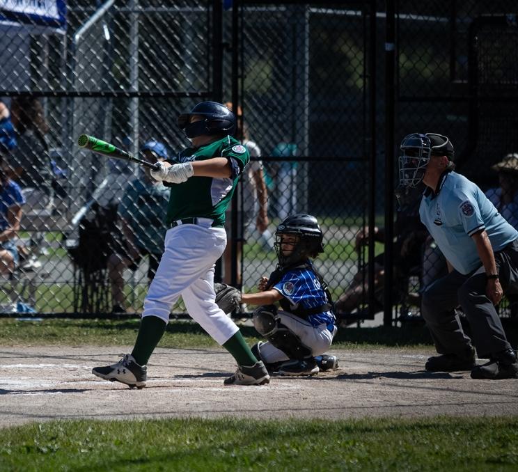 A Layritz Little League player hits a home run during a little league game in Victoria, BC