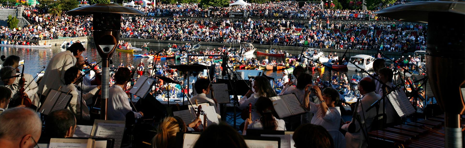 The Victoria Symphony performs from a floating stage on the Inner Harbour during Symphony Splash! In Victoria, BC
