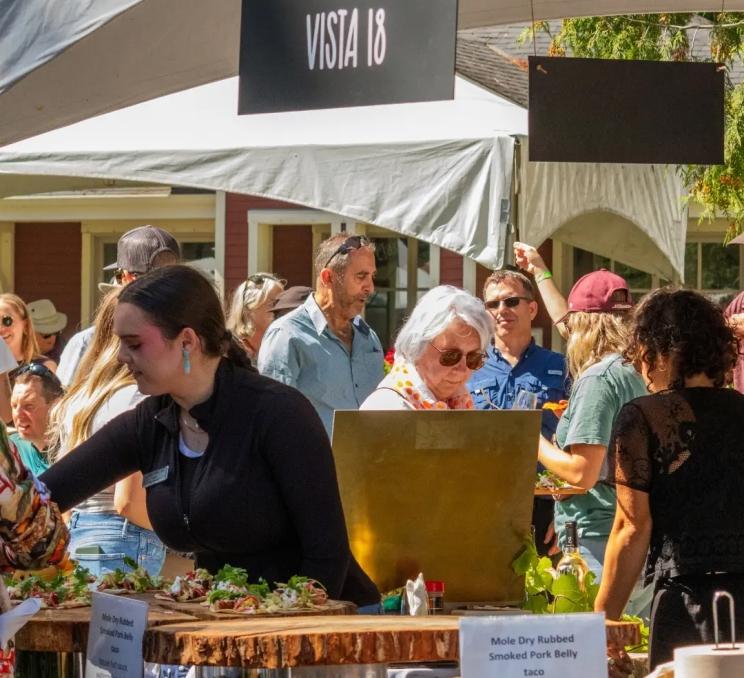 A group of diners visit a food stall at the Feast of Fields in Victoria, BC