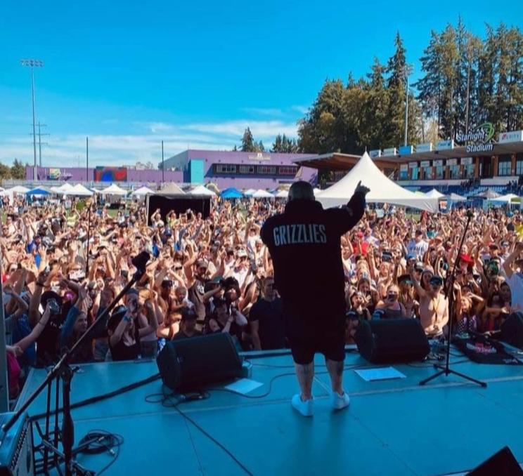 A performer on stage at SoberFest as the crowd cheers at Starlight Stadium in Greater Victoria, BC