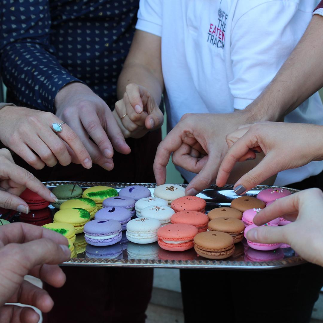 A group tries an assortment of Macarons during an Off the Eaten Track food tour in Victoria, BC