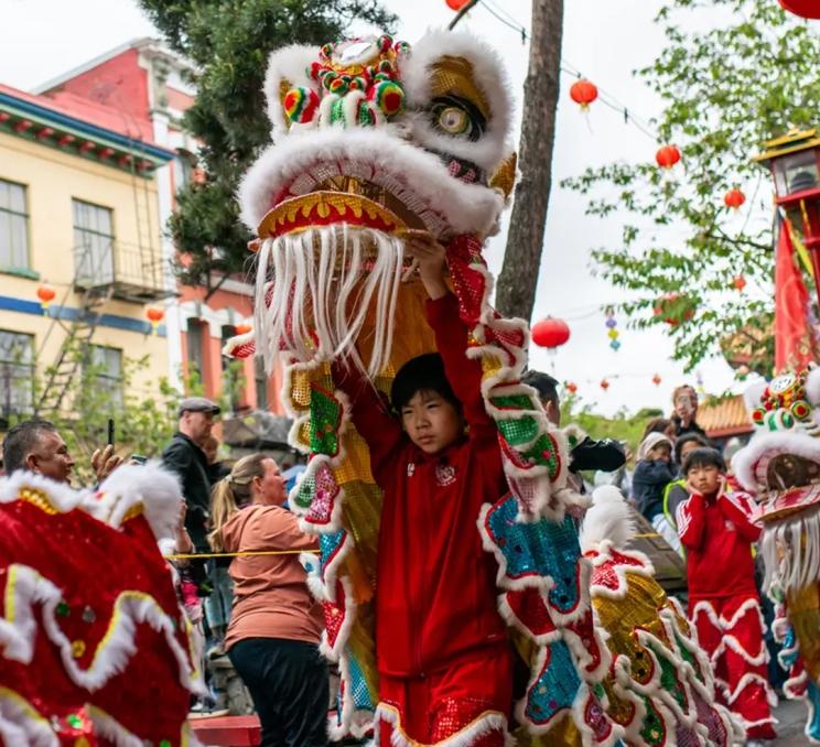 A dragon dance featuring a red dragon performs at the Awakening Chinatown Festival in Canada's oldest Chinatown in Victoria, BC