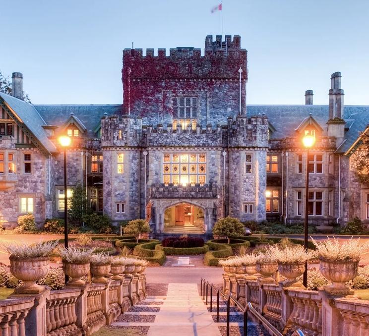 The facade of Hatley Castle, a National Historic Site of Canada, illuminated at dusk in Victoria, BC