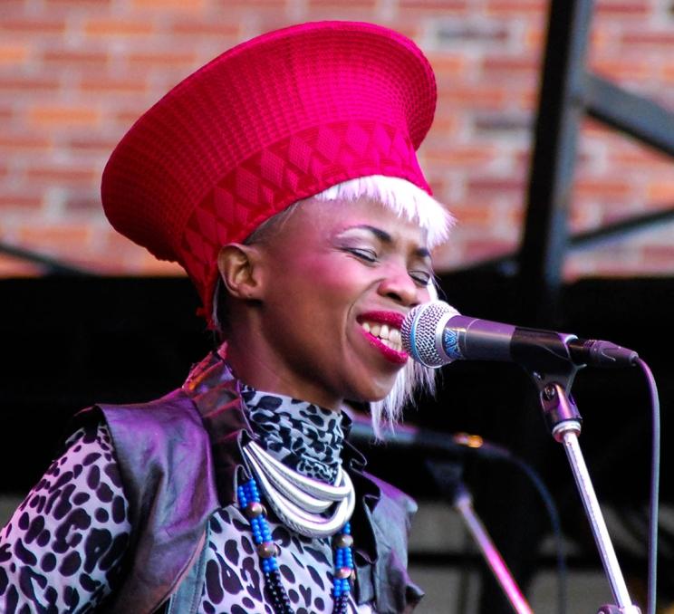 A woman wearing a red sings into a microphone during TD International Jazz Fest in Victoria, BC