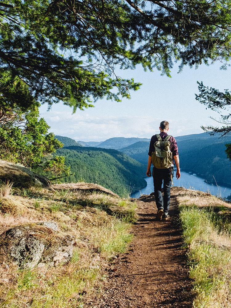 A man hikes along a trail at Gowland Tod Provincial Park in Victoria, BC
