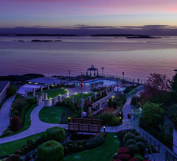 A sunrise casts purple hues across the mineral pools at the Oak Bay Beach Hotel in Victoria, BC