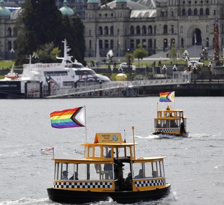 Yellow Harbour Ferries flying pride flags on Victoria, BC's Inner Harbour