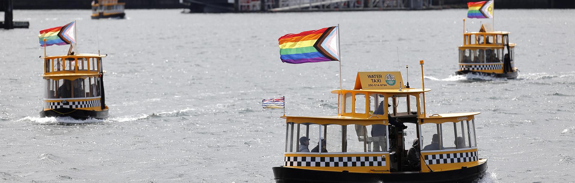 Water Taxis flying pride flags on the Inner Harbour in Victoria, BC