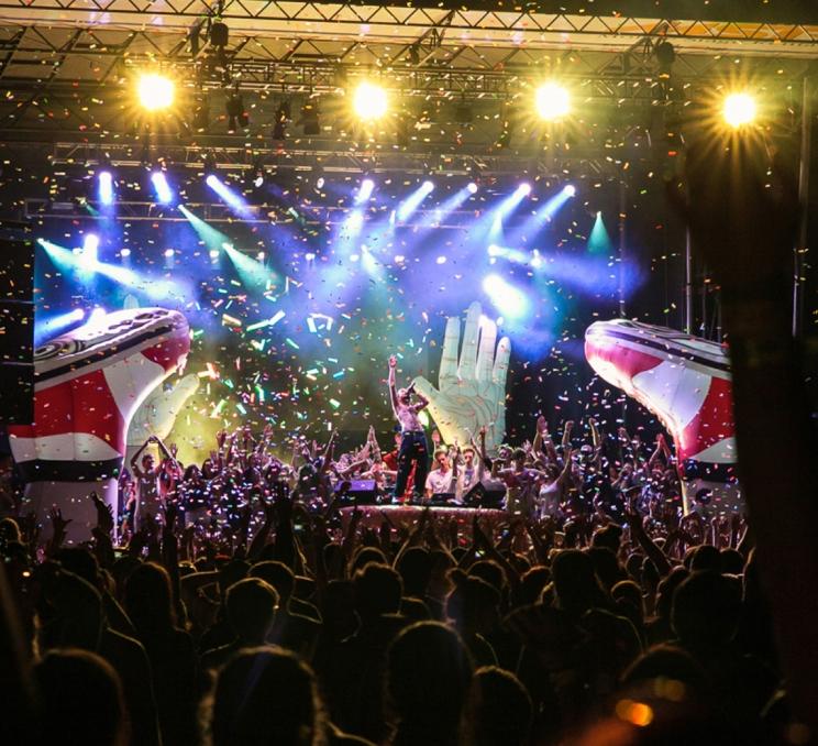 A performer sings on stage in front of a crowd at the Rifflandia Music Festival in Victoria, BC