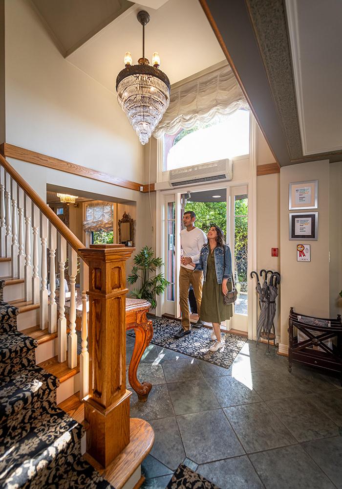 A couple enters Abigail's Hotel a boutique hotel in Victoria, BC
