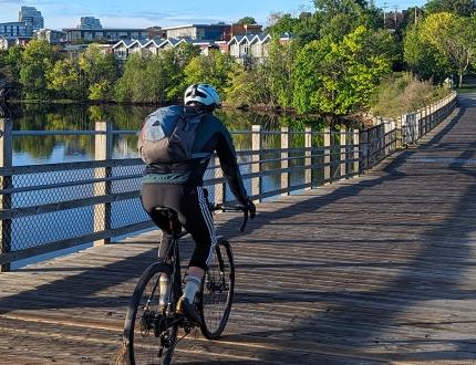 A cyclist rides along the Selkirk Trestle at Sunrise in Victoria, BC