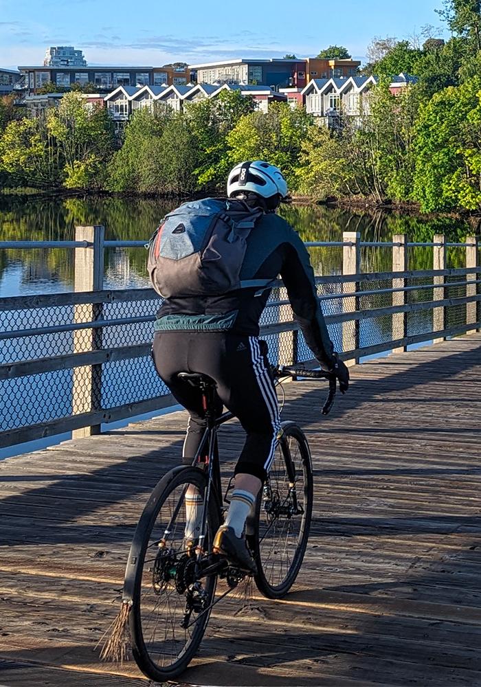 A cyclist rides their bike across the Selkirk Trestle along the Galloping Goose Regional Trail in Victoria, BC