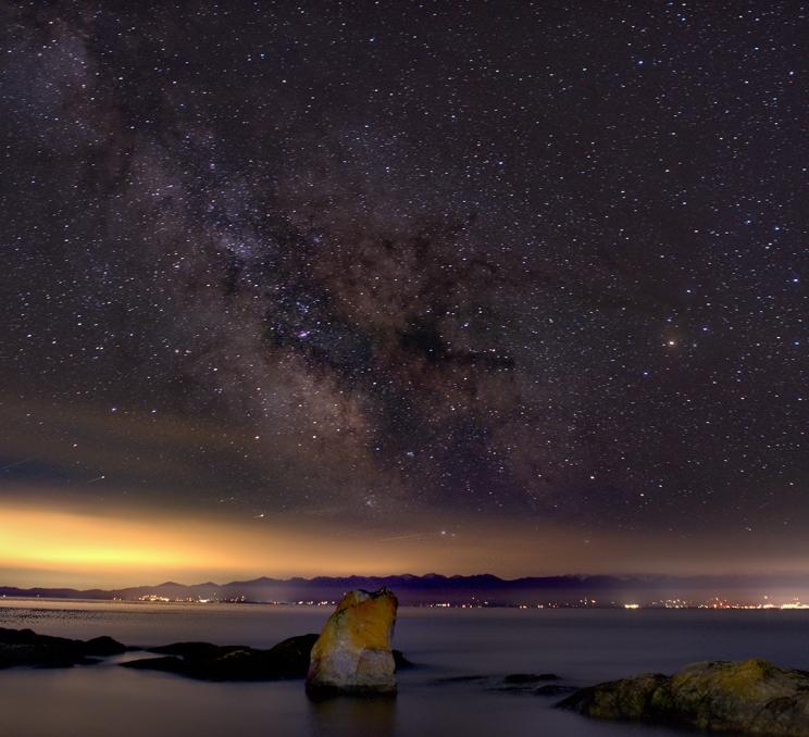 The milky way appears in the sky above Harling Point in Victoria, BC