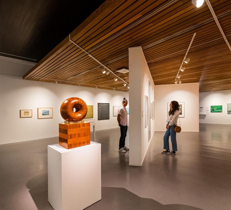 A young couple examines art in the Art Gallery of Greater Victoria, in Victoria, BC