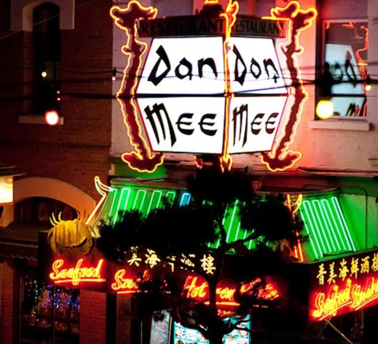 The Don Mee Seafood House sign lit up at night in Victoria, BC