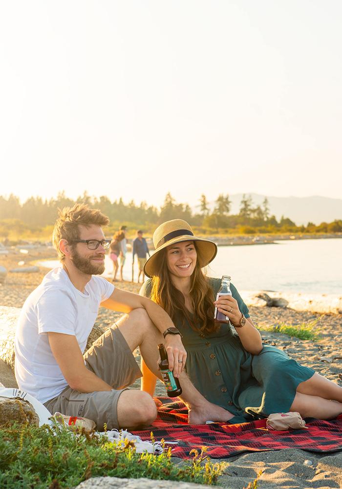 A couple enjoys a picnic on the beach in Victoria, BC