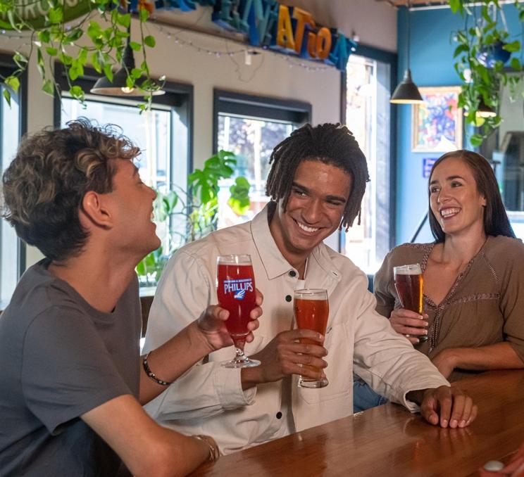 A group of friends enjoy a pint at Phillips Brewing & Malting in Victoria, BC