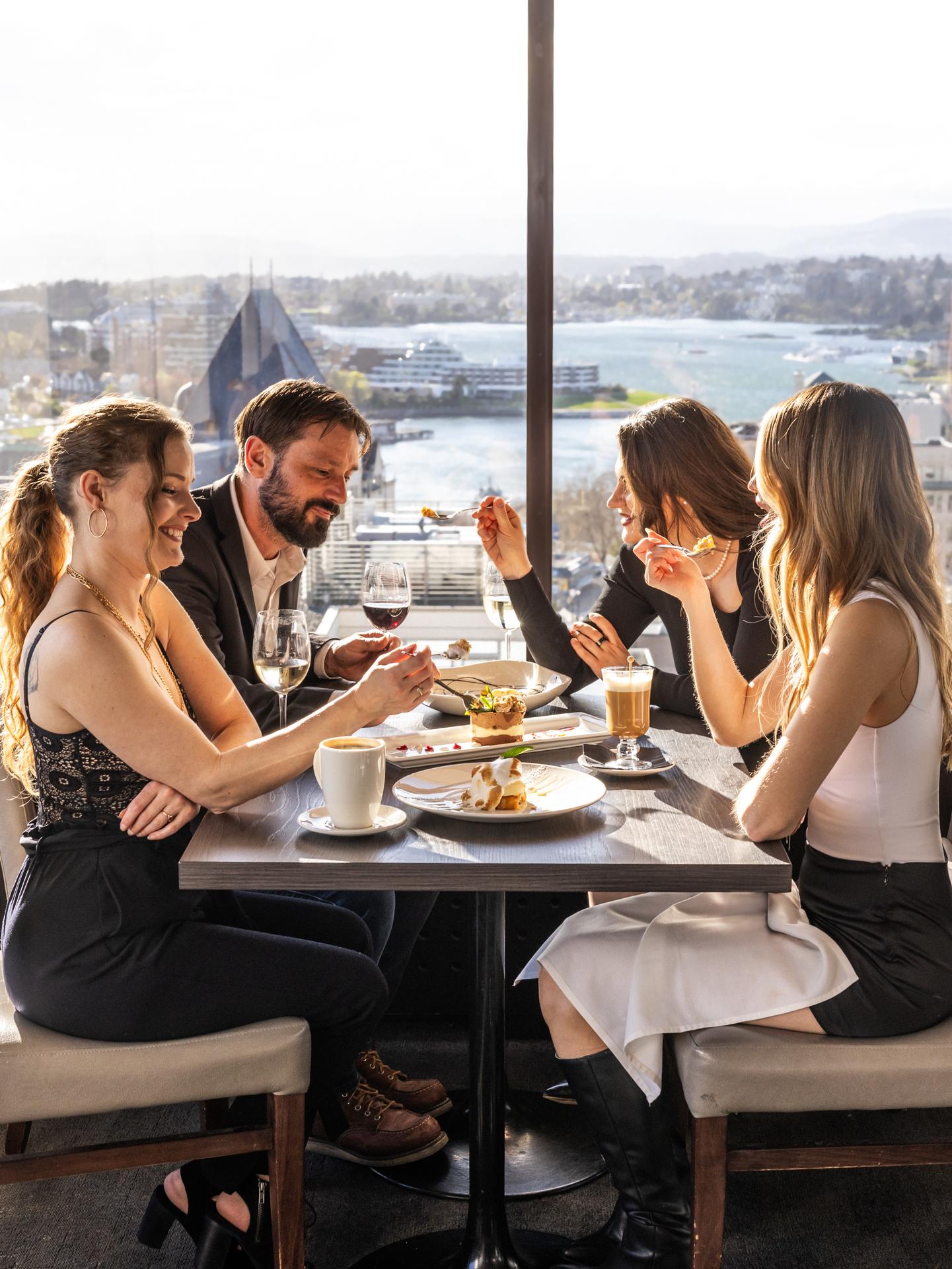 A group of four dining at Vista 18 at Chateau Victoria's rooftop restaurant for Dine Around 2026.