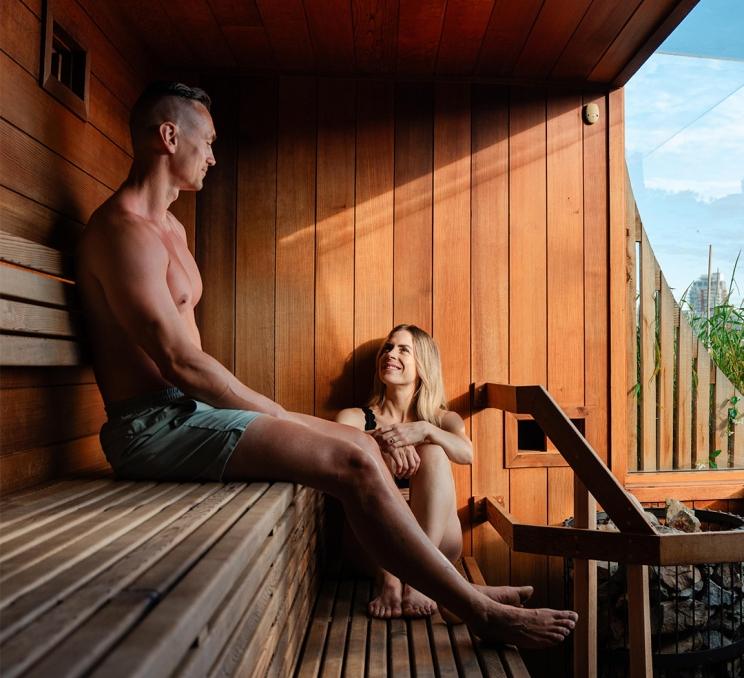 A couple sits inside a sauna on the Inner Harbour at HAVN Saunas in Victoria, BC