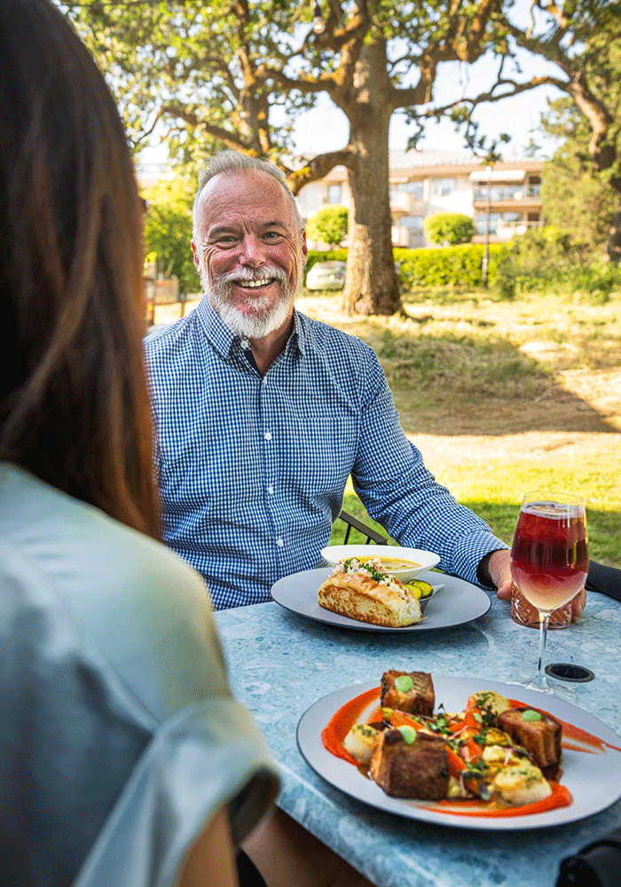A couple dines on the patio at Fireside Grill in Victoria, BC