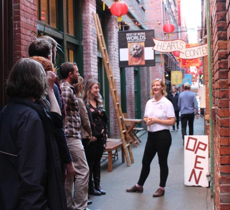 An Off the Eaten Track food tour stops in Fan Tan Alley, Canada's narrowest street, in Victoria, BC's historic Chinatown.