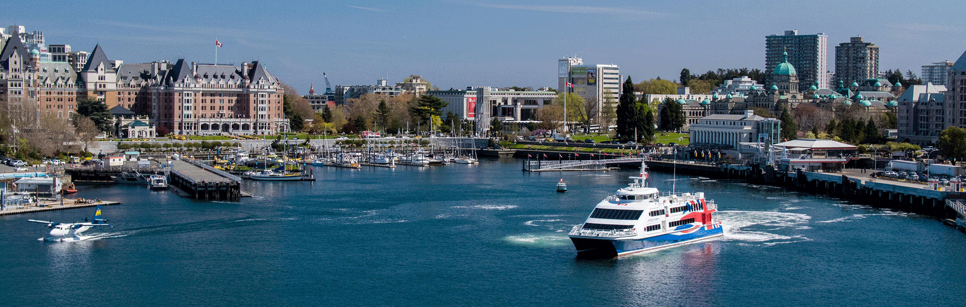 The FRS Clipper, a ferry offering downtown to downtown ferry service between Seattle and Victoria, BC, cruises in Victoria's Inner Harbour