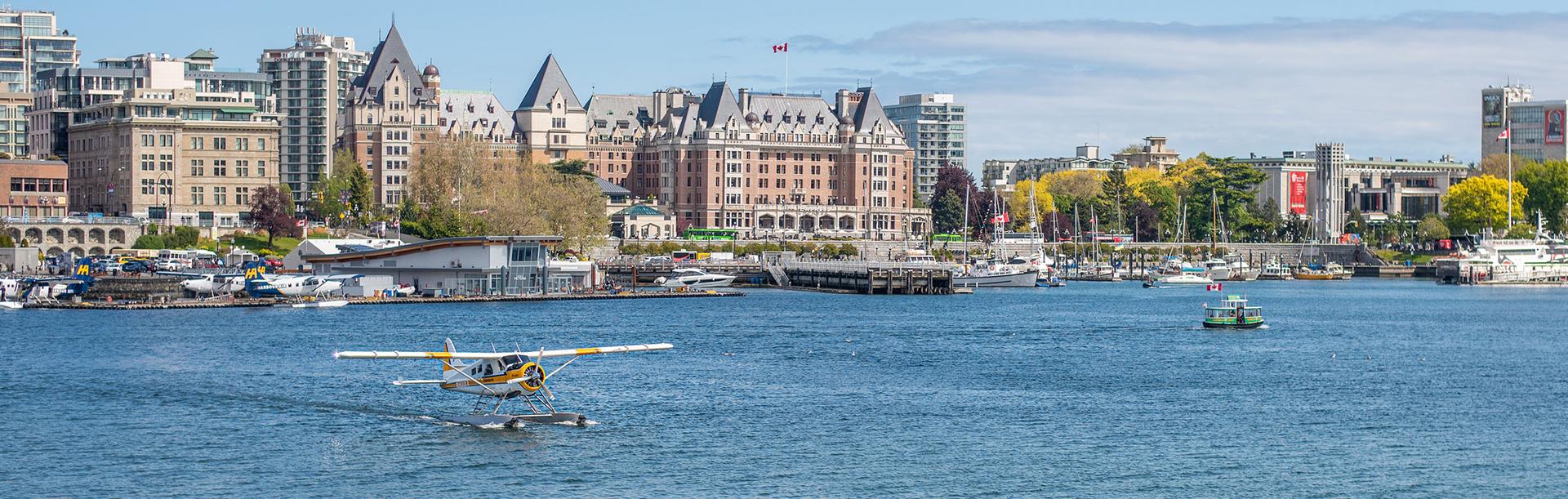 A Kenmore Air seaplane taxis across the Inner Harbour in Victoria, BC