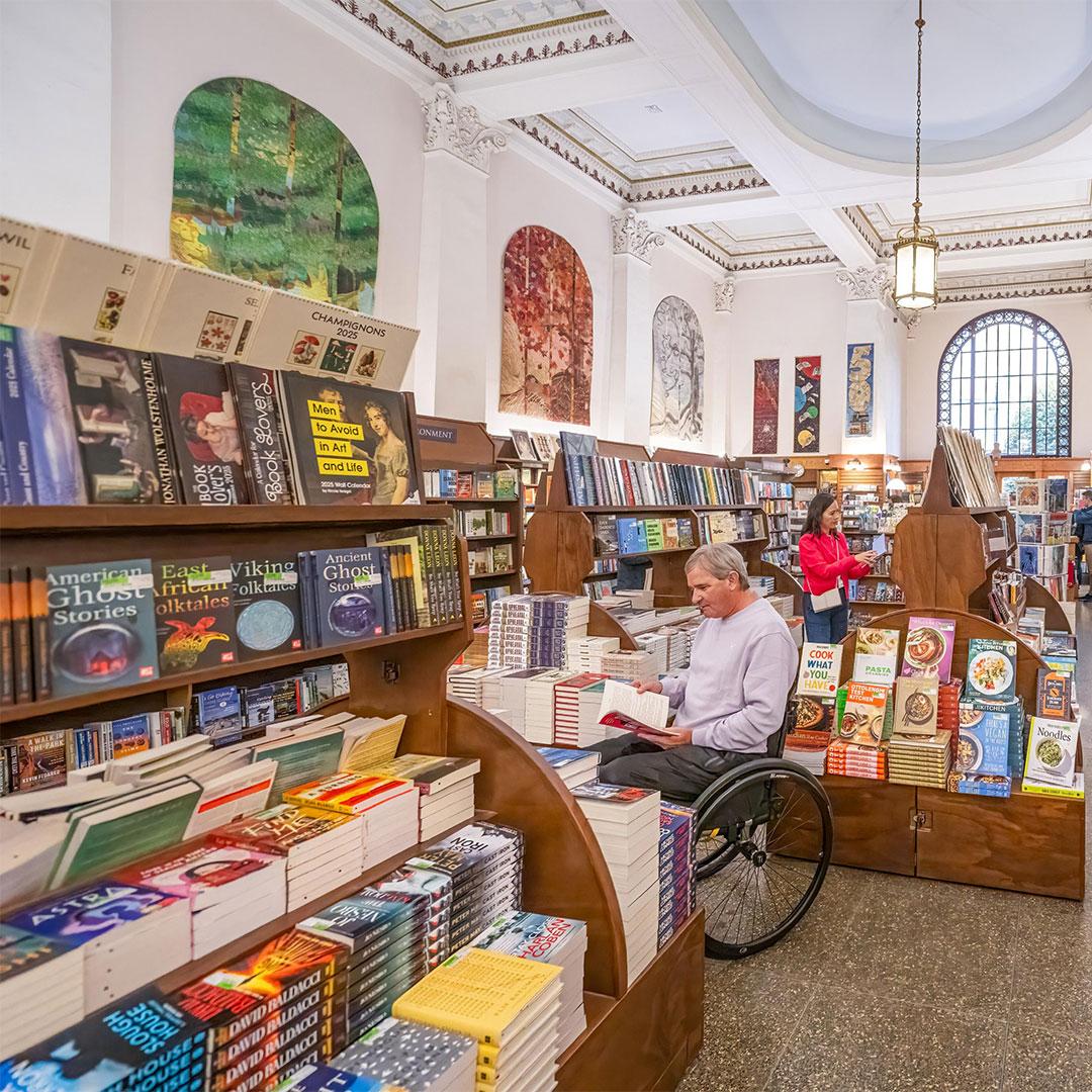 A couple shopping for books inside Munro's Books on Government Street in Victoria, BC