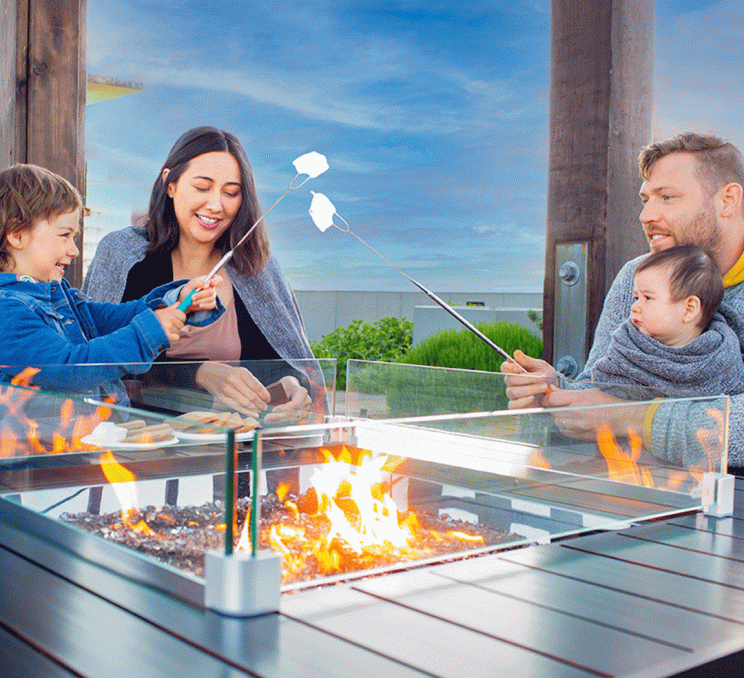 A family roasting S'mores on the rooftop at the Parkside Hotel & Spa in Victoria, BC
