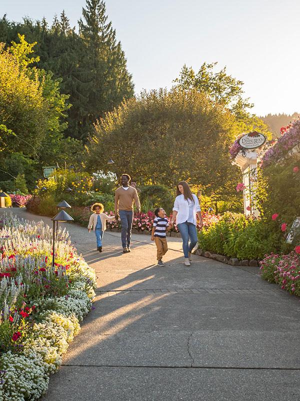 A young family walks together through The Butchart Gardens in Victoria, BC