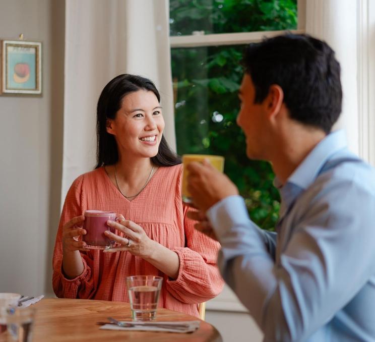 A couple enjoys lattes at Nourish Kitchen & Cafe in Victoria, BC