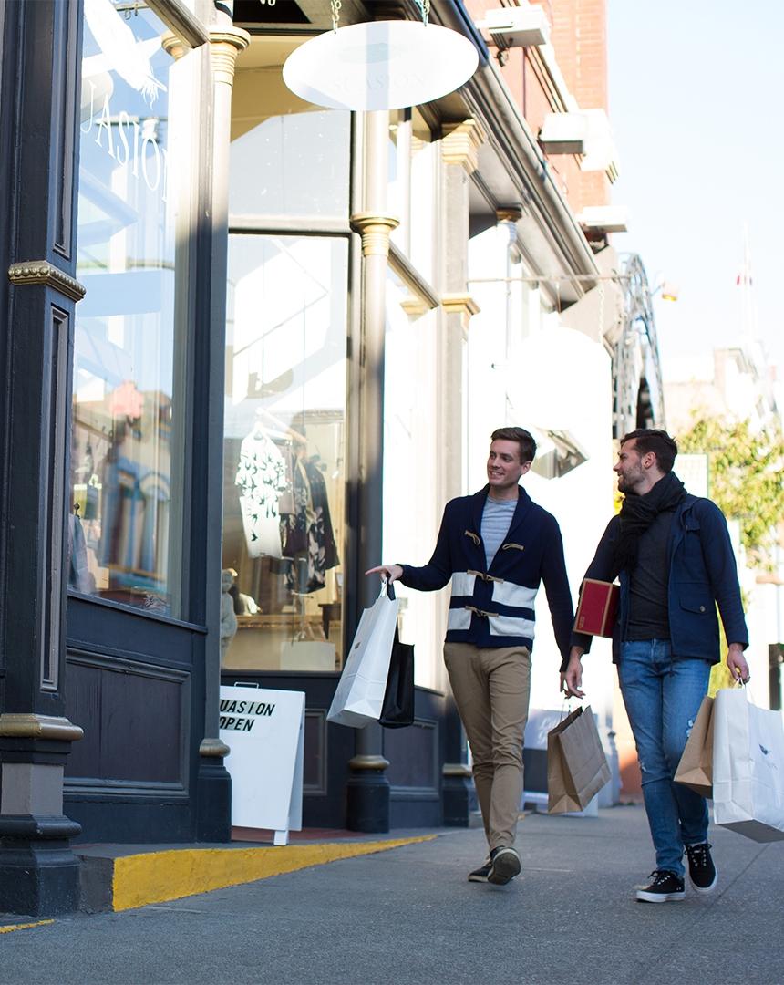 A male couple shopping along Lower Johnson Street in Victoria, BC