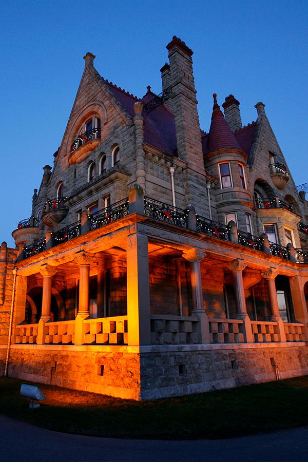 Craigdarroch Castle Historic House Museum illuminated at twilight in Victoria, BC