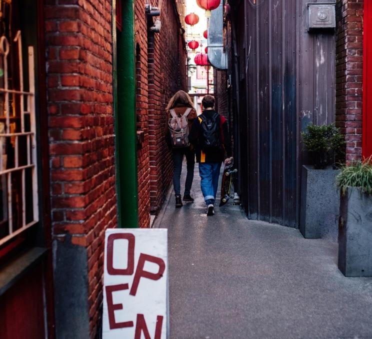 Two people walking down Fan Tan Alley in Victoria, BC